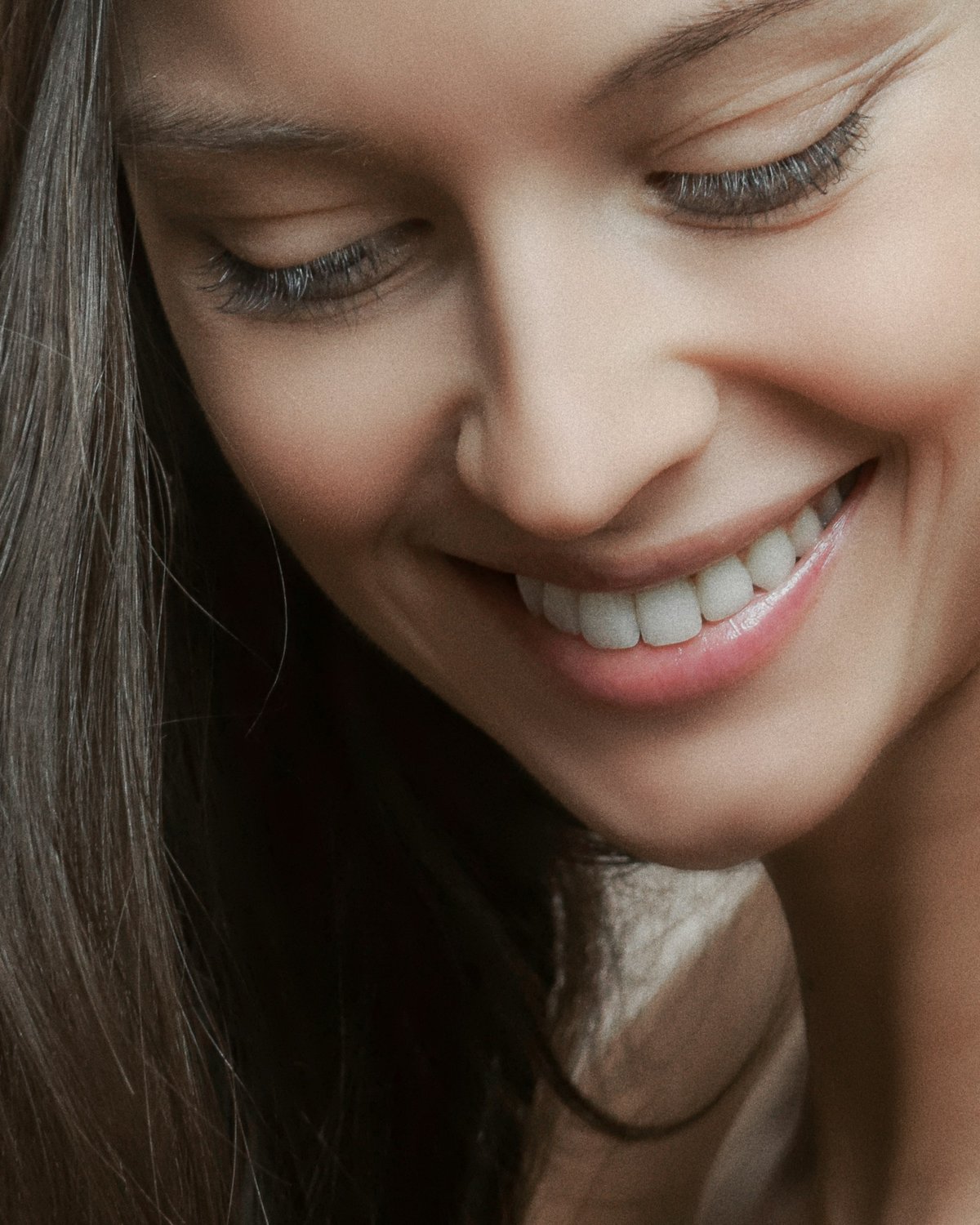 A smiling woman with white, even teeth